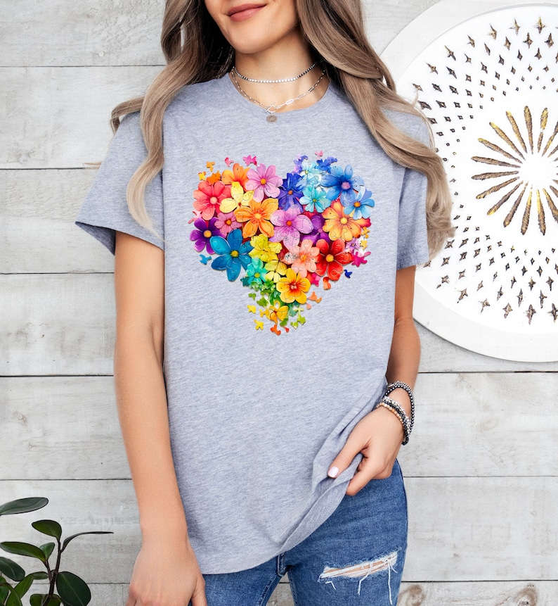 a woman wearing a t - shirt with a heart made of flowers