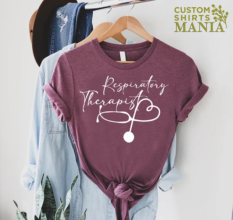 May include: A maroon t-shirt with the text "Respiratory Therapist" and a white stethoscope graphic.