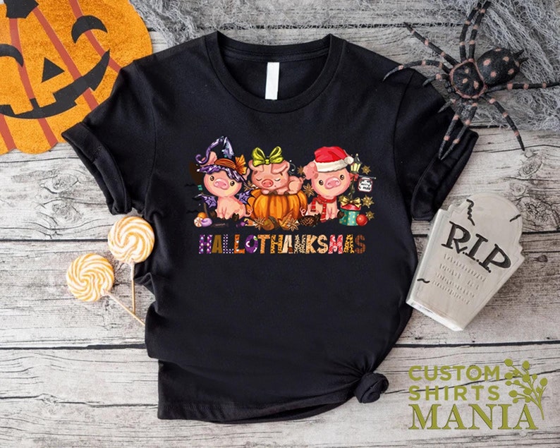 a black t - shirt with three cartoon characters on it