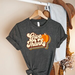 a t - shirt that says give thanks on it