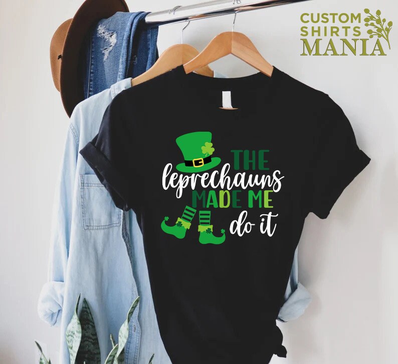 May include: Black t-shirt with a green leprechaun graphic and the text "The Leprechauns Made Me Do It".