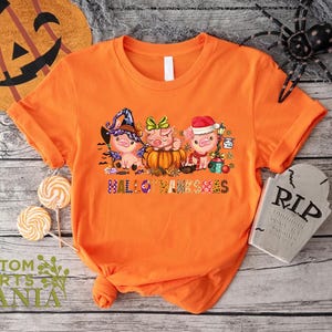 an orange shirt with three little pigs on it