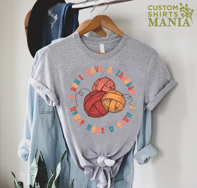 May include: Gray t-shirt with a colorful graphic of yarn balls and the text "I don't have a problem I have a yarn stash".
