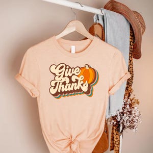 a t - shirt that says give thanks on it