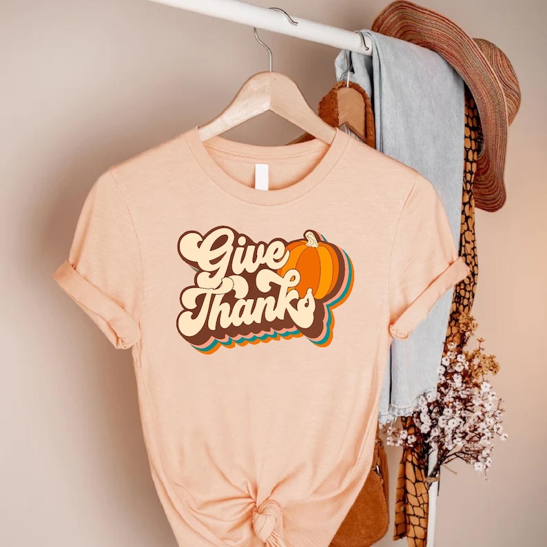 a t - shirt that says give thanks on it