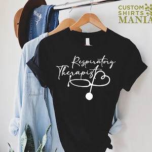May include: Black t-shirt with white text that reads "Respiratory Therapist" and a stethoscope with a heart shape.