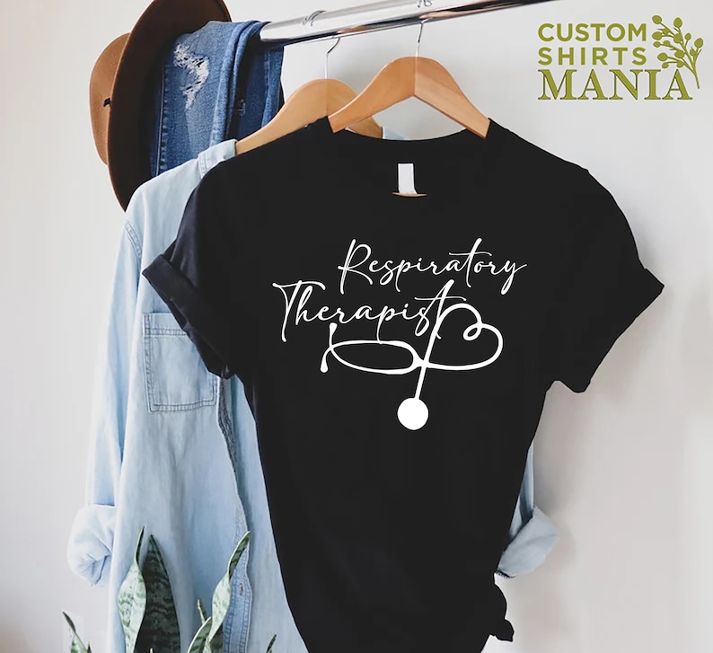 May include: Black t-shirt with white text that reads "Respiratory Therapist" and a stethoscope with a heart shape.