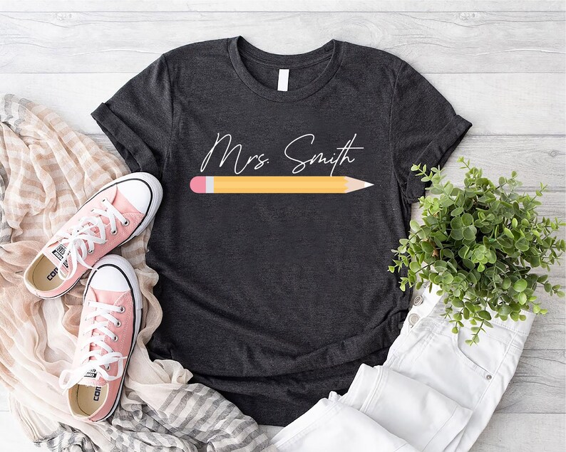 a t - shirt with a pencil and a pair of sneakers