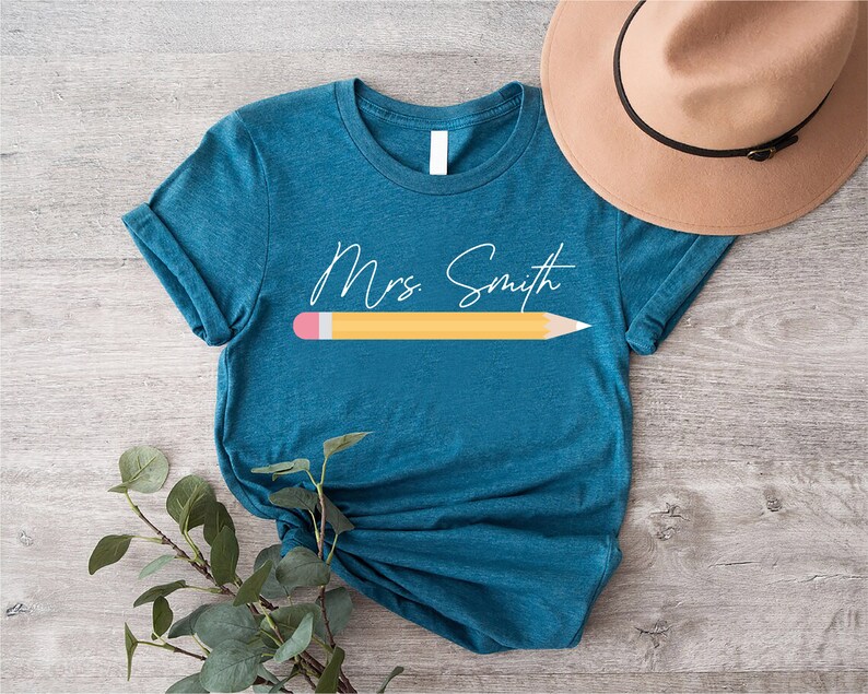 a t - shirt with a pencil on it and a hat