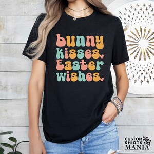 a woman wearing a black t - shirt that says bunny kisses easter wishes