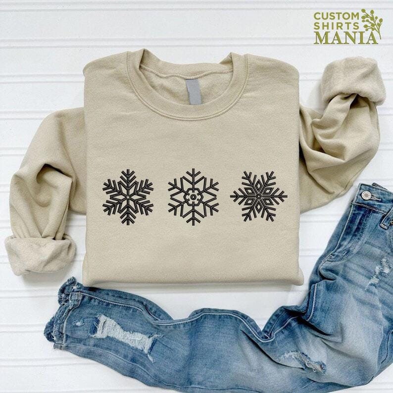 a pair of jeans and a sweater with snowflakes on them