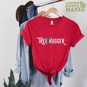 May include: Red t-shirt with a white graphic that says "Tree Hugger" and a small green tree icon.