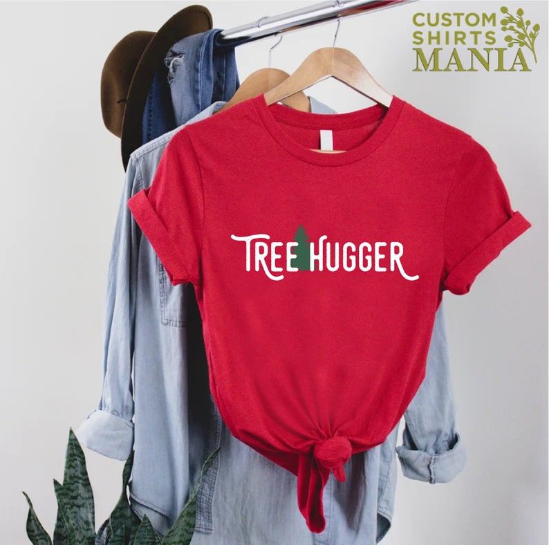 May include: Red t-shirt with a white graphic that says "Tree Hugger" and a small green tree icon.