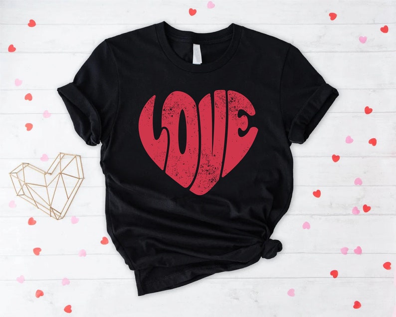 May include: Black t-shirt with a red heart-shaped graphic that says "LOVE" in a retro font.