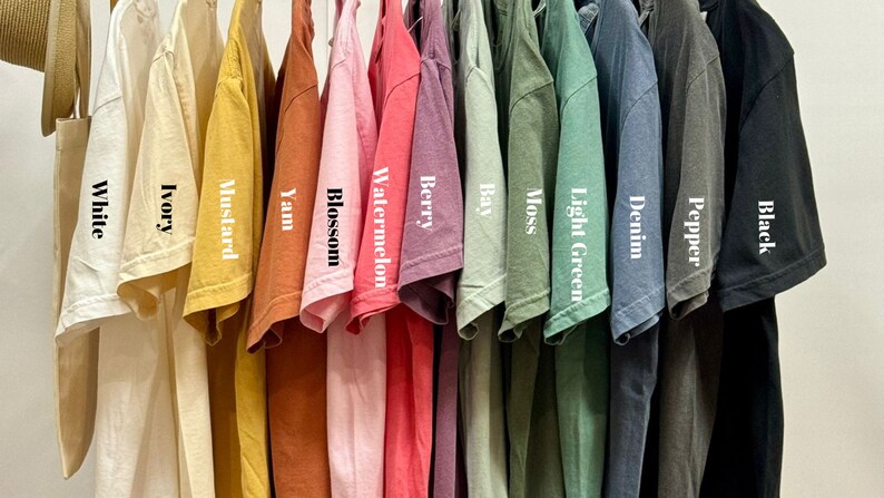 a bunch of shirts hanging on a rack