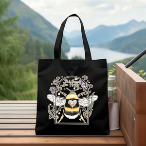 a black bag with a picture of a bee on it