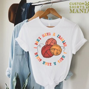 May include: White t-shirt with a colorful graphic of yarn balls and the text "I don't have a problem I have yarn stash".