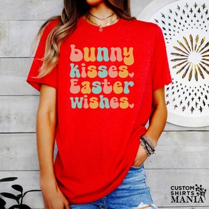 a woman wearing a red shirt that says bunny kisses, easter wishes