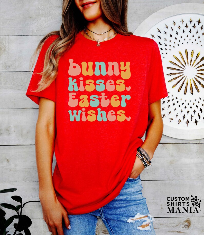 a woman wearing a red shirt that says bunny kisses, easter wishes