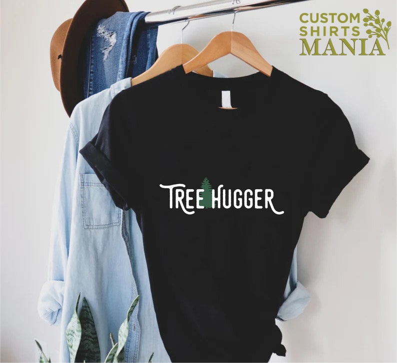 May include: Black t-shirt with a green tree graphic and the text "Tree Hugger" in white.