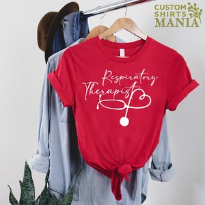 May include: Red t-shirt with white text that reads "Respiratory Therapist" and a stethoscope graphic.