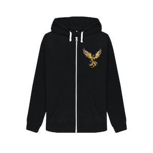 May include: Black zip-up hoodie with a white zipper and drawstring. A gold phoenix design is on the upper left chest. The hoodie has a hood and two front pockets. The material appears to be a soft, comfortable fabric.