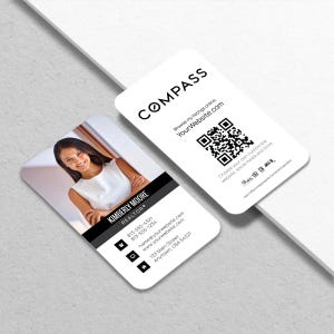 May include: Two white business cards with rounded corners. One card features a photo of a woman and the text "KIMBERLY MOORE REALTOR®". The other card has the "COMPASS" logo and a QR code. Contact information is also included.
