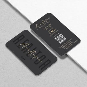 May include: Two dark gray business cards with rounded corners. One card features the name "Anastasia Henderson" in gold script, the words "YOUR FAVORITE REALTOR", and social media icons. The other card says "REALTOR" in large gold letters and "Anastasia Real Estate".