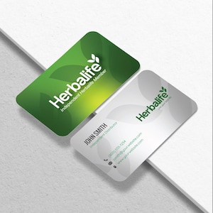 a business card with a green leaf on it