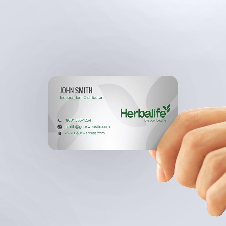 a hand holding a business card that says herblife