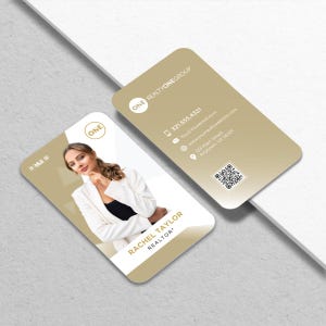 May include: Two business cards with rounded corners. One card features a photo of a woman in a white blazer, with the text "RACHEL TAYLOR, REALTOR". The other card displays contact information, including a phone number, email, website, and address, along with the "ONE REALTYONEGROUP" logo.