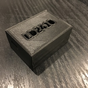 May include: A black 3D printed box with the word "LD2410" printed on the top.