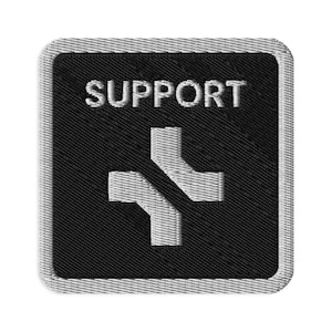 May include: Embroidered patch with the word "SUPPORT" in white block letters above a white cross with a diagonal black line through it. The patch has a black background and a gray border.