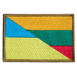 May include: Embroidered patch with a geometric design in shades of blue, yellow, green, and red. The patch has a brown border and a textured appearance, suggesting it is made of fabric.
