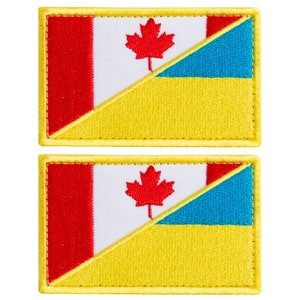 May include: Two embroidered patches featuring a split design. One side displays the Canadian flag with a red maple leaf on a white background and a red border. The other side shows the Ukrainian flag with a blue and yellow design.