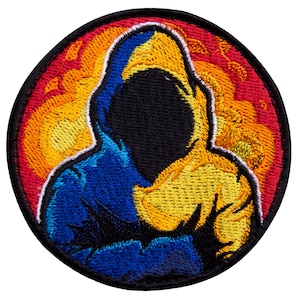 May include: Embroidered patch featuring a hooded figure with a black face and a split design of blue and yellow. The figure is set against a fiery orange and red background, with a black border.
