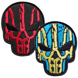 May include: Two embroidered patches in the shape of a skull. One patch is black with a red skull design. The other patch is black with a skull design in blue and yellow. Both patches have a black border.