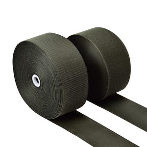May include: Two rolls of olive green hook and loop tape, or Velcro, are shown against a white backdrop. The rolls are tightly wound, with the tape extending from each roll. The texture of the tape is visible.