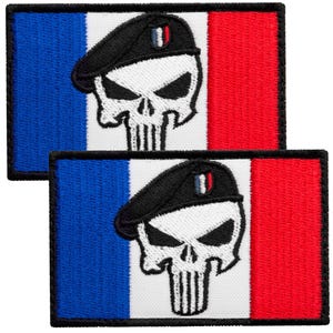 May include: Two rectangular embroidered patches featuring the French flag with vertical blue, white, and red stripes. Centered on each patch is a white skull graphic wearing a black beret with a small blue, white, and red emblem.