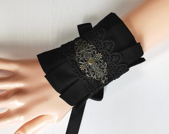 Elegant cuffs in gothic, romantic, Victorian, steampunk style, in black cotton fabric, with lace and bronze metal ornaments