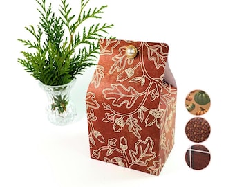 May include: A small, red and white patterned gift box with a pearl-like button closure. The box has a design of oak leaves and acorns.