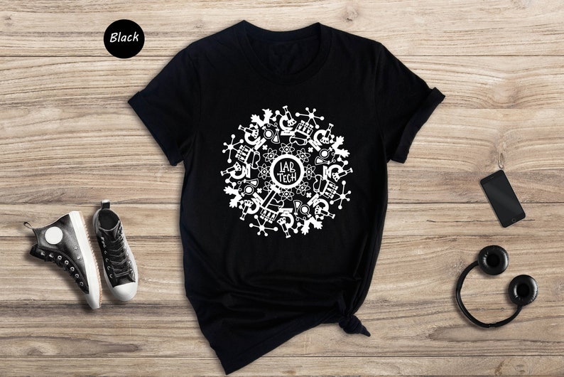 May include: Black t-shirt with a white design of a circle with science lab equipment and the text "Lab Tech" in the center.