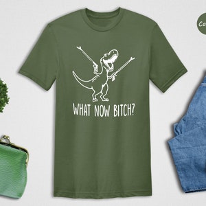 a t - shirt that says, what now factor? next to a pair of