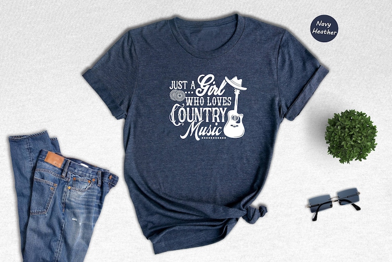 May include: A navy blue t-shirt with the text "Just a Girl Who Loves Country Music" and a guitar graphic.