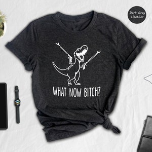 a t - shirt that says what now sits next to a briefcase