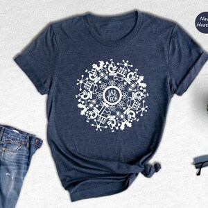 May include: A navy heather t-shirt with a white design of a circle with science lab equipment and the text "Lab Tech".