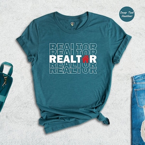 May include: Teal blue t-shirt with the word "REALTOR" repeated in white text with a red house icon in the centre.