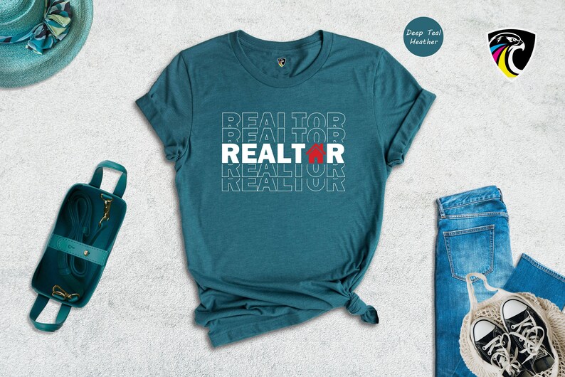 May include: Teal blue t-shirt with the word "REALTOR" repeated in white text with a red house icon in the centre.