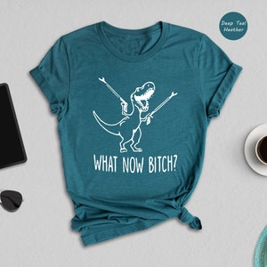 a t - shirt that says what now before next to a cup of coffee and