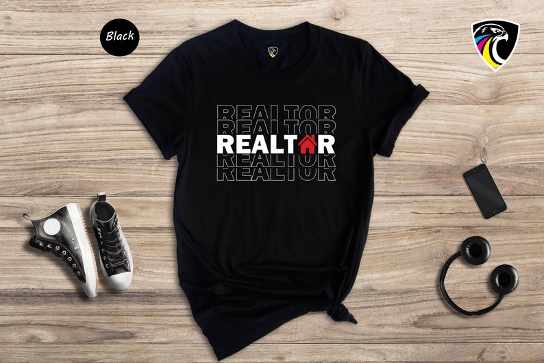 May include: Black t-shirt with the word "REALTOR" repeated in white text with a red house icon in the centre.